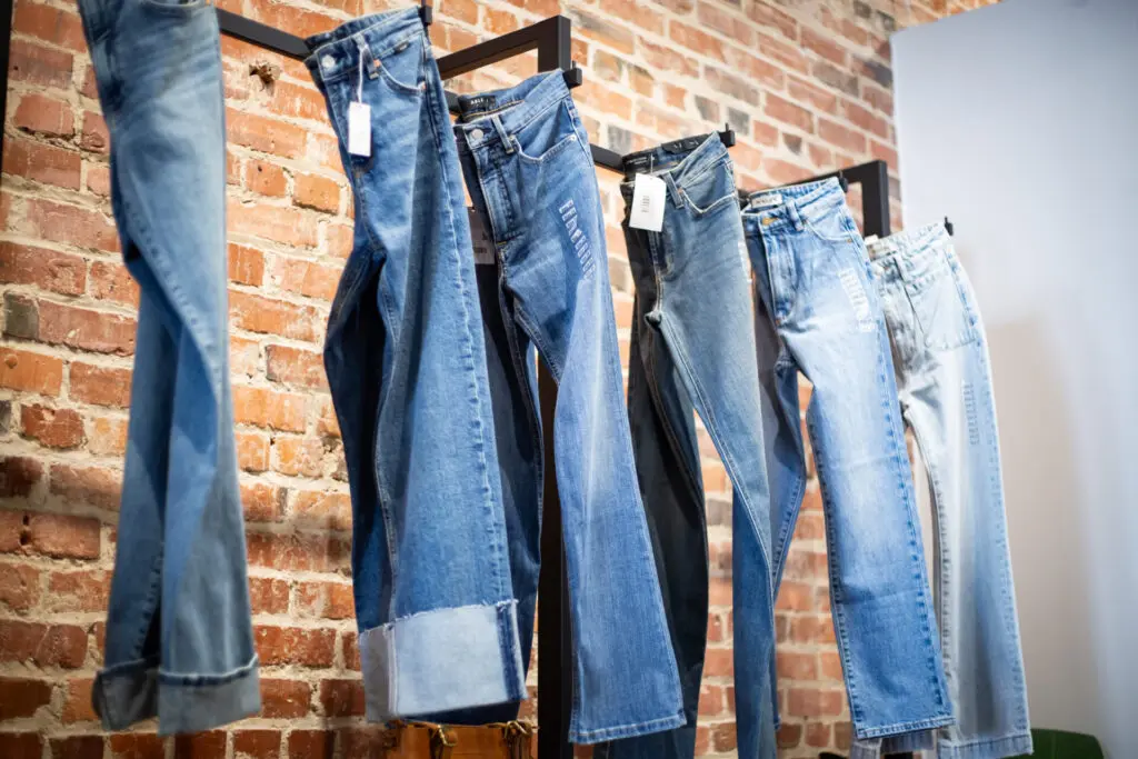 Rack of blue jeans hanging in a store in a downtown Durham.