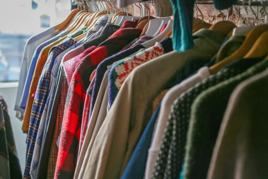 A rack of men's vintage tops in a variety of colors.