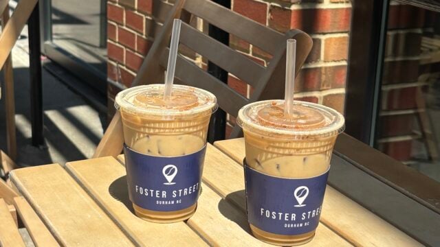 two iced pumpkin spice lattes on a table outside