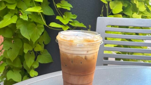 S'mores iced latte sitting on a table with a plant